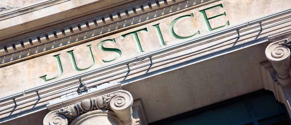 JUSTICE sign on a building facade